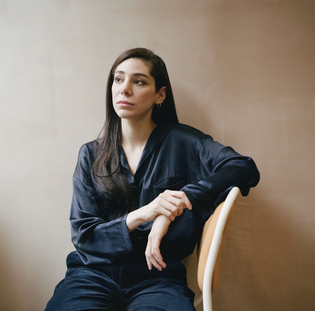 Artist Dala Nasser sitting on a chair